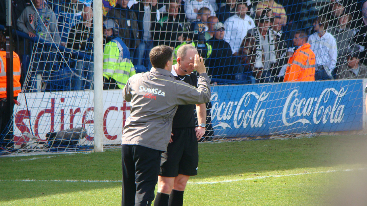 Football photograph: Mike Dean Has Treatment.